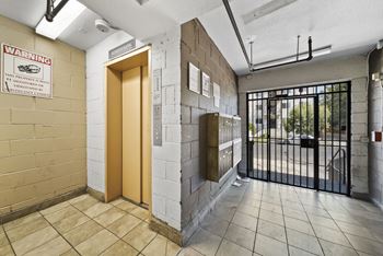 A warning sign is on the wall in front of a door.